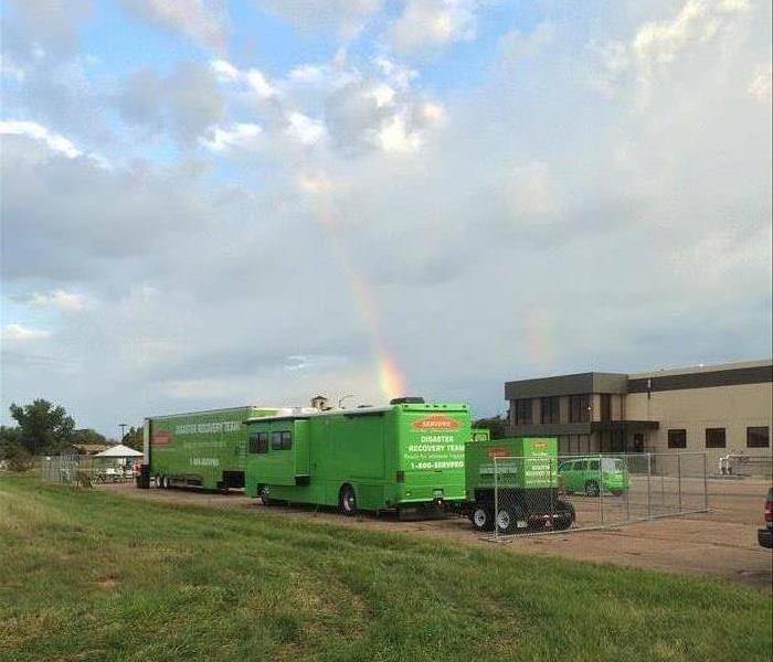Trucks with rainbow in the background