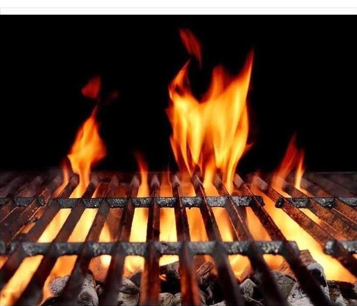 Hot Empty Charcoal BBQ Grill With Bright Flames On The Black Background. Cookout Concept.